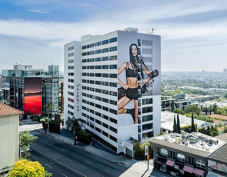 Exterior of the hotel building with a woman in fitness apparel painted on the side